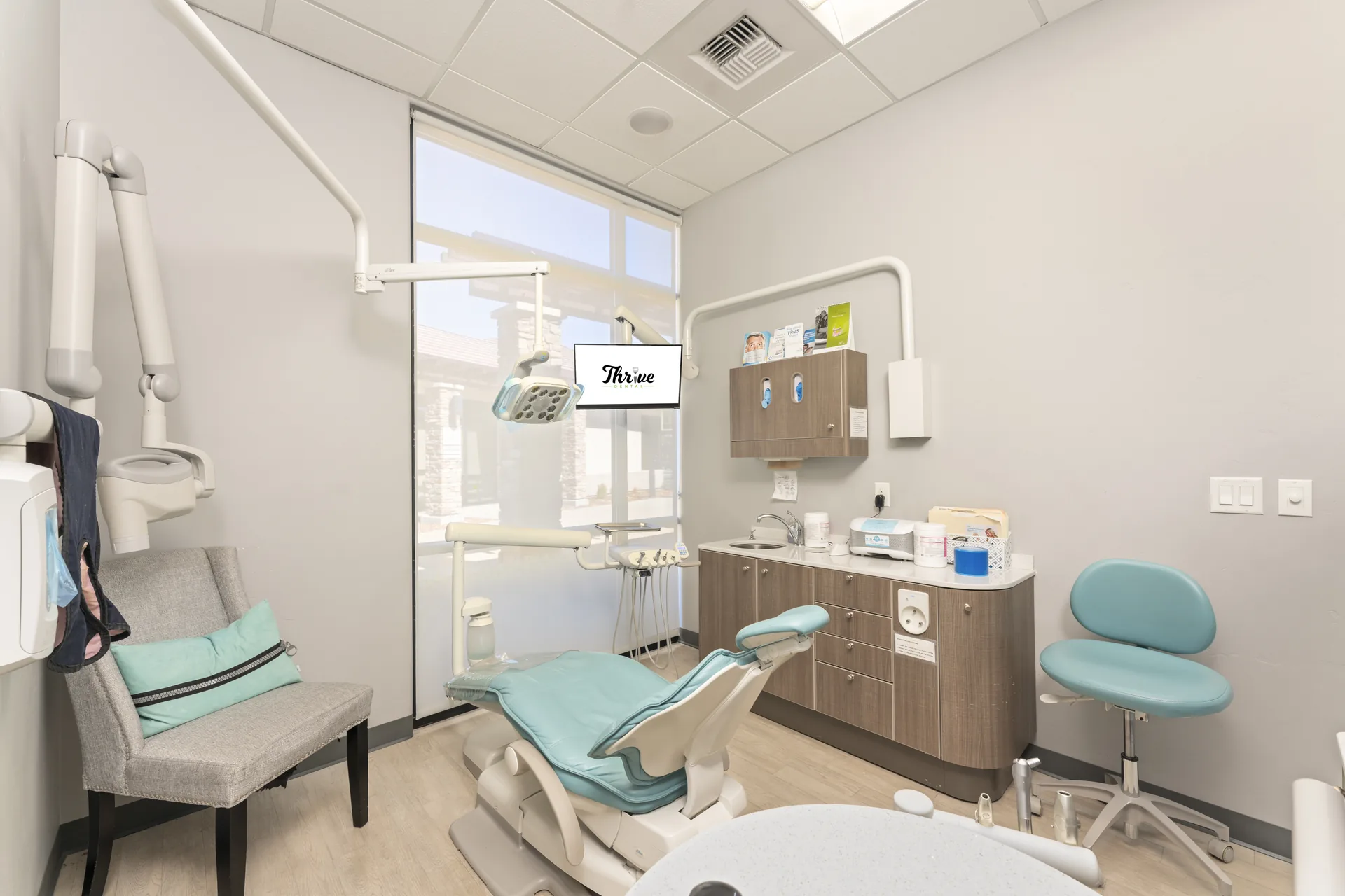 Modern Thrive Dental treatment room with natural light and comfortable seating