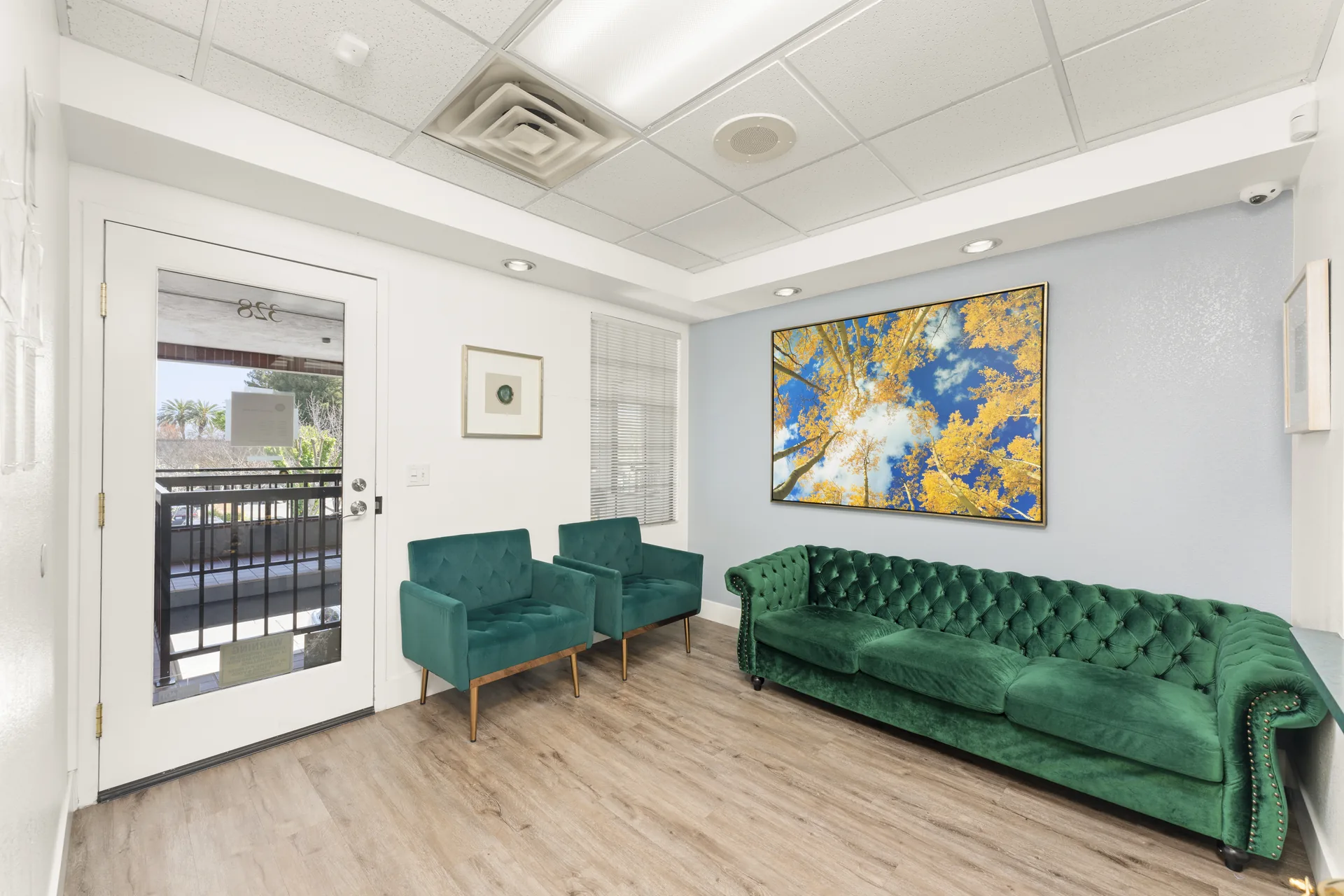 Welcoming waiting room with green velvet furniture at Thrive Dental Stockton