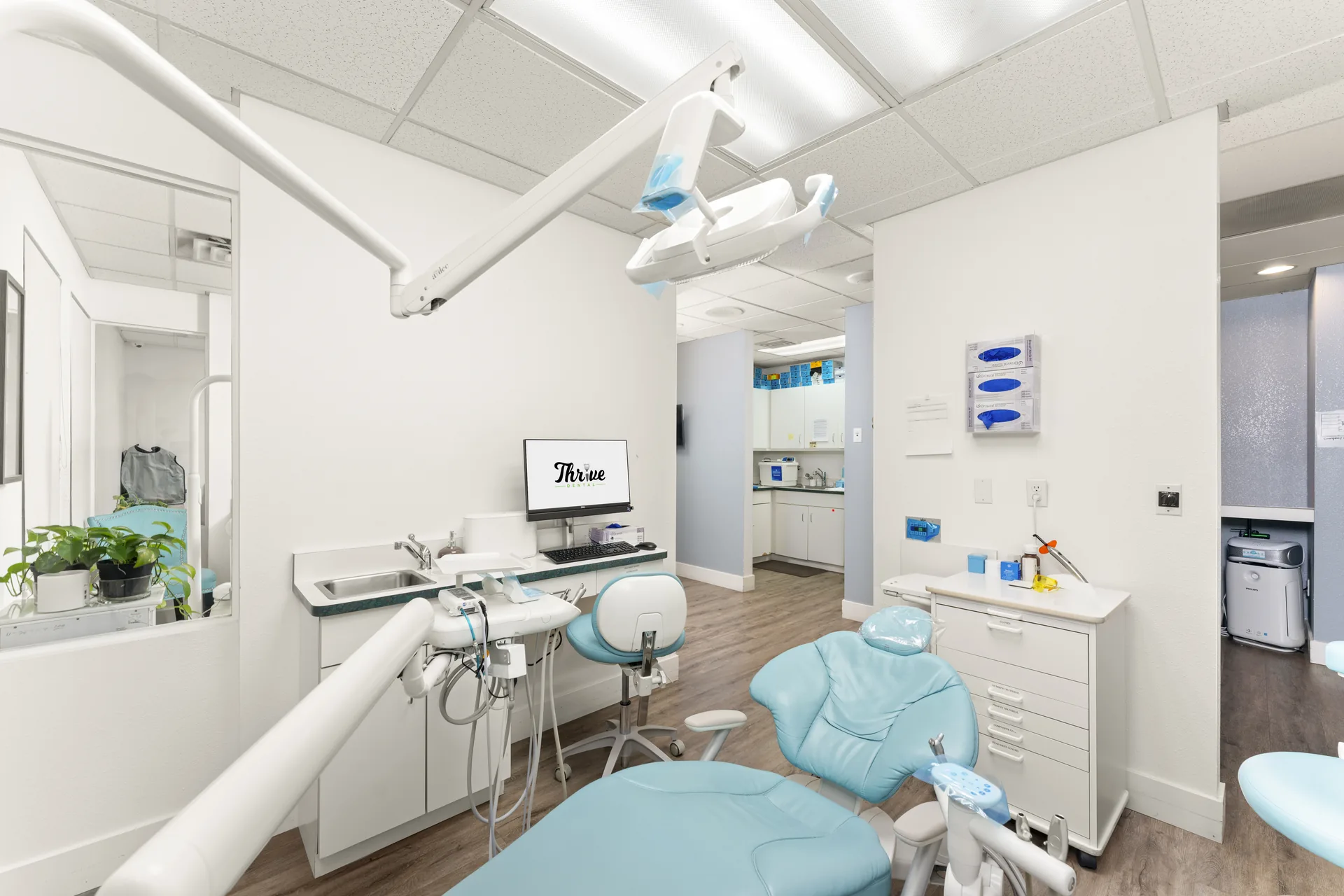 Modern operatory with plants and artwork at Thrive Dental Stockton